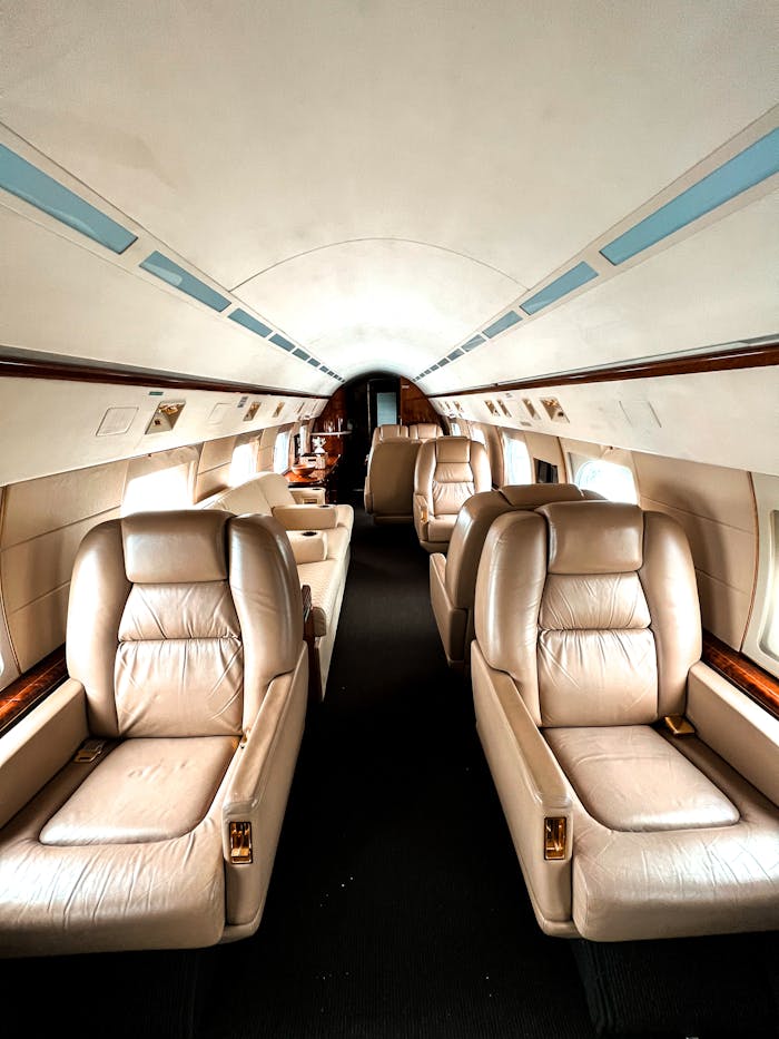 Elegant interior of a private jet showcasing luxurious leather seating for exclusive travel experience.